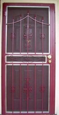 Maroon security door with decorative black metal bars and a gold knob against a light wall