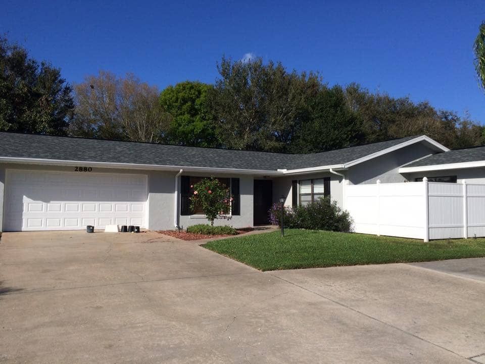 Local Home Featuring Large Garage and Shingle Roofing Surface