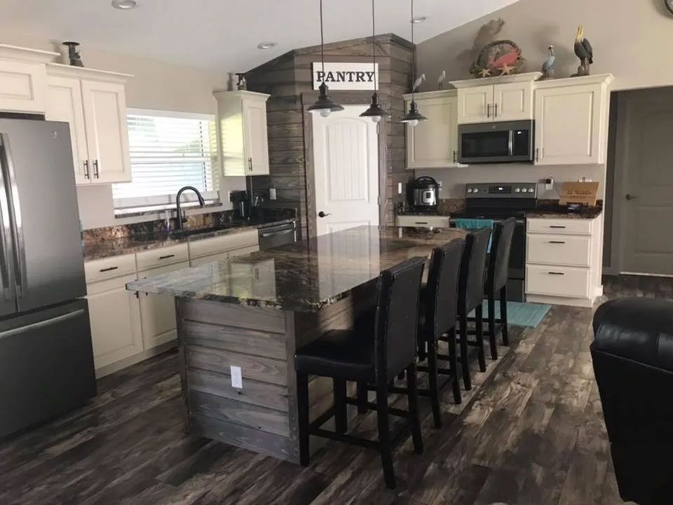 Renovated Kitchen Featuring Stone Island and New Seating