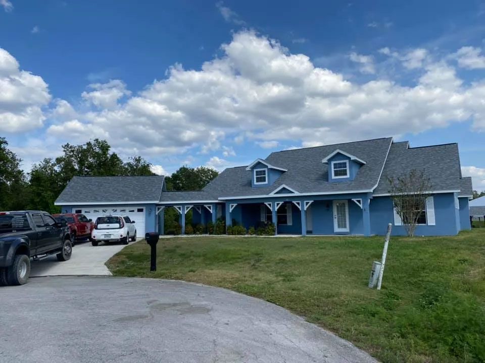 Blue Home With Updated Shingle Roofing Surface