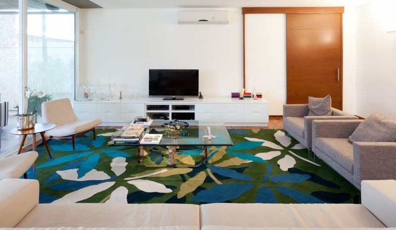 Uma sala de estar com tapete e TV de tela plana