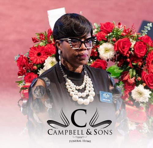 Woman in black attire and pearls before red and white floral arrangement with Campbell & Sons logo