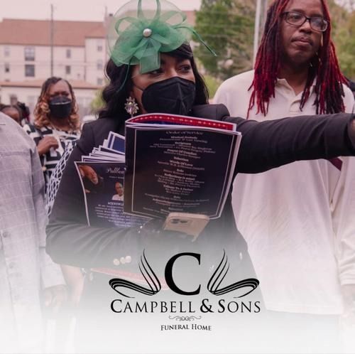 Mourners at a memorial procession, one holding a funeral program and pointing ahead, with Campbell & Sons logo below