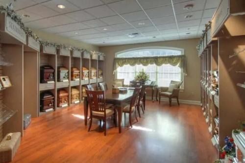 Bright conference room with table, chairs, bookshelves, and large window light