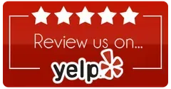 A red sign that says `` review us on yelp '' A red sign that says `` review us on yelp ''