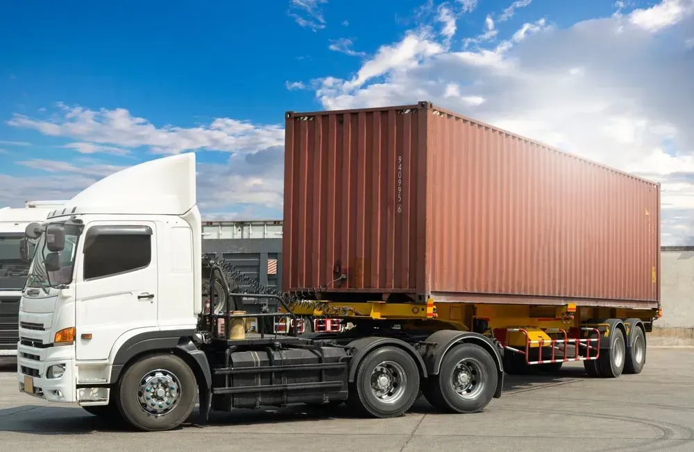 A White Semi-Truck Pulling a Large Brown Shipping Container — Tamworth Tilt Trays in Tamworth, NSW