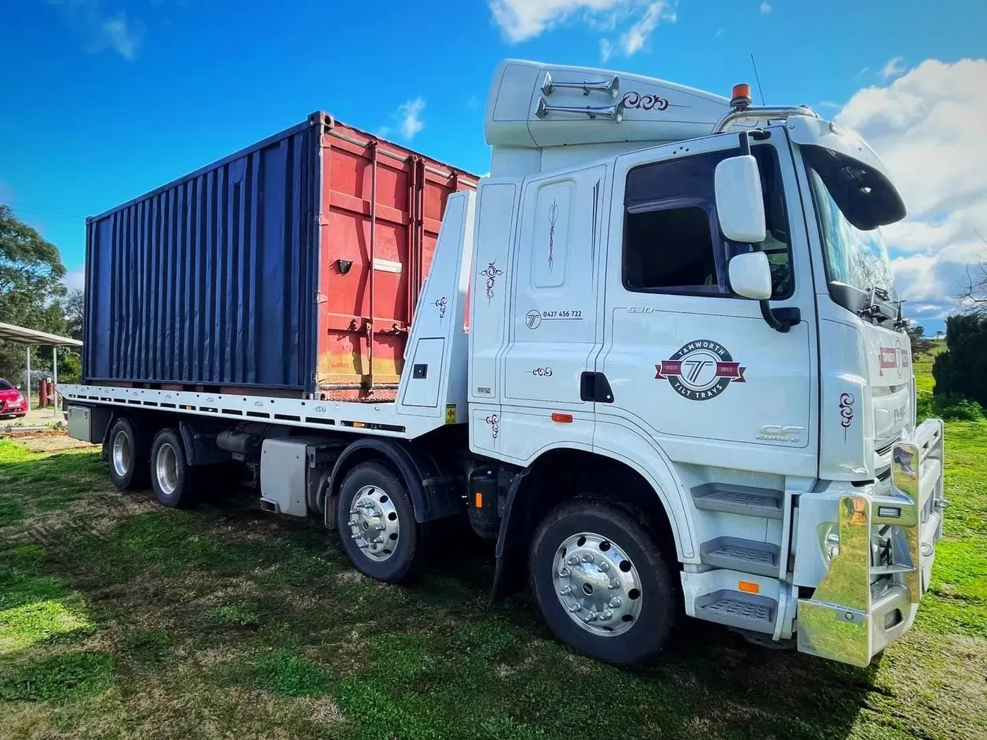 A White Flatbed Truck Carrying a Dark Red Shipping Container — Tamworth Tilt Trays in Tamworth, NSW