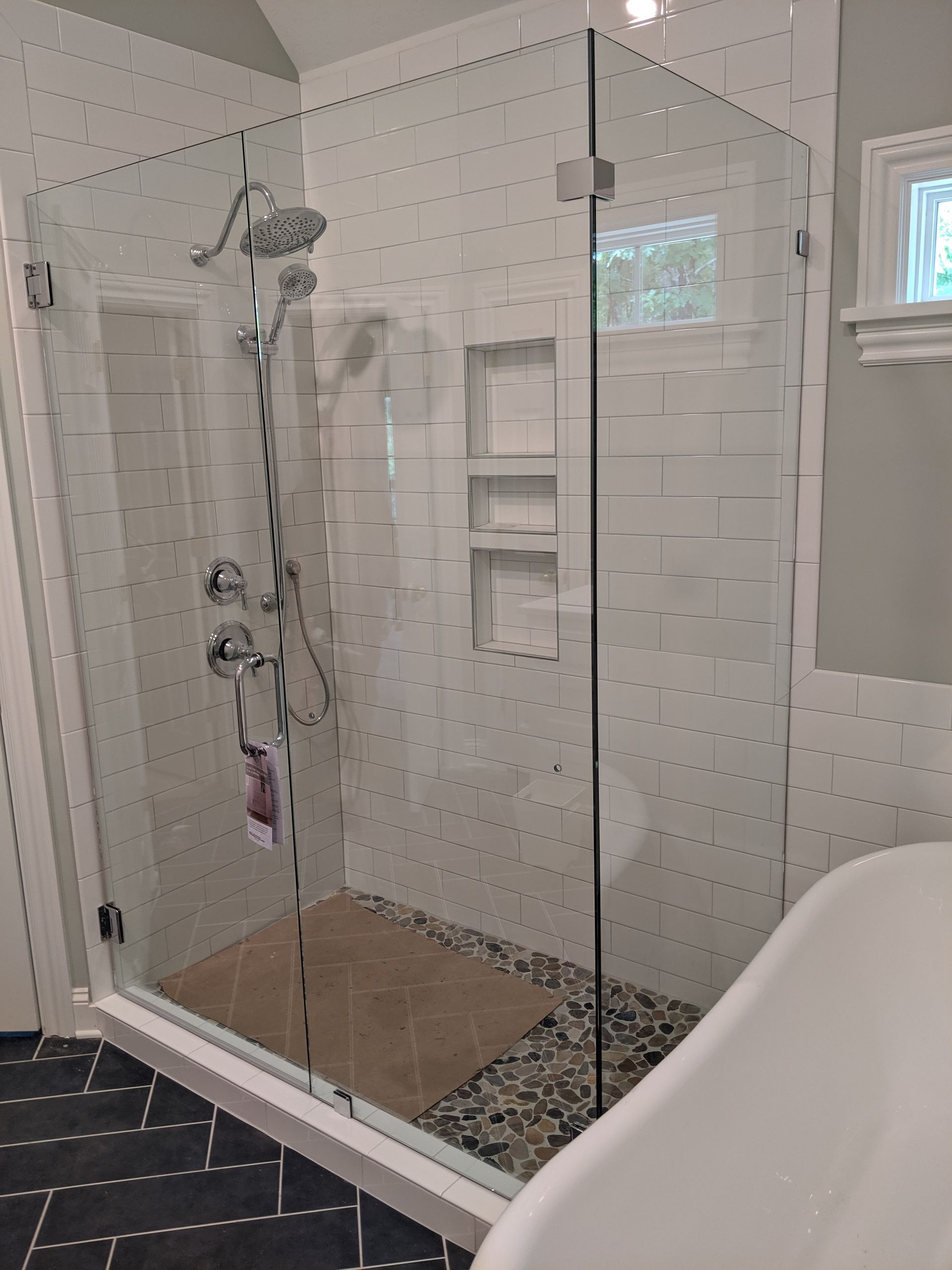 A bathroom with a walk in shower and a bathtub.