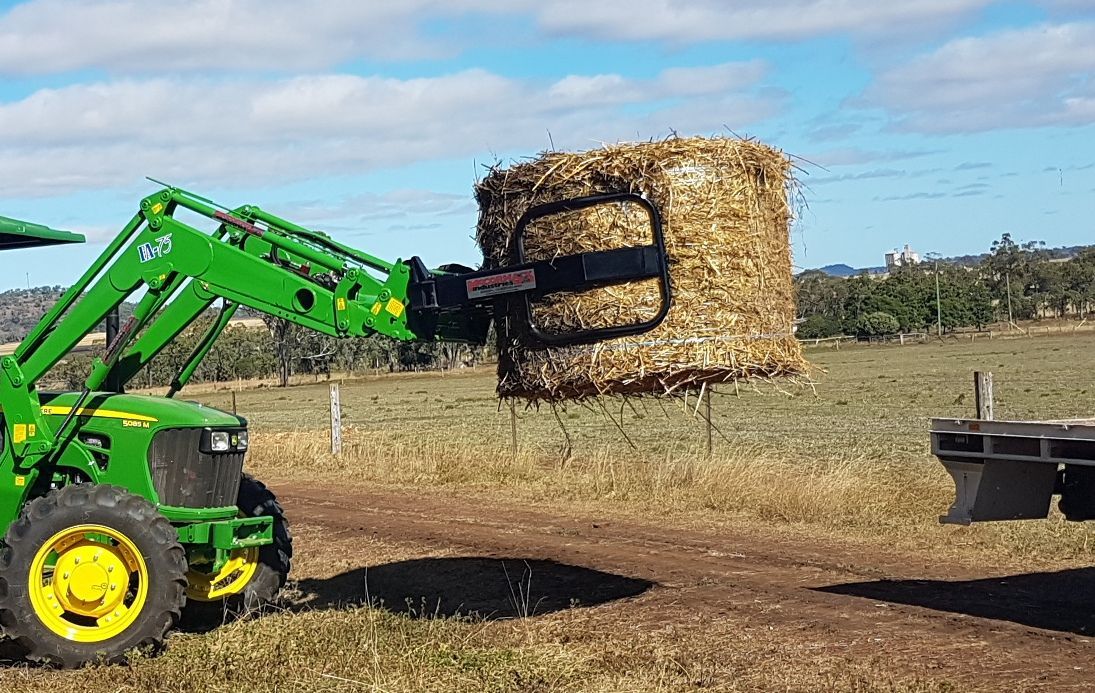 John Deere with round bale grab