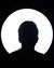 Silhouetted person centered in front of a bright white circular background