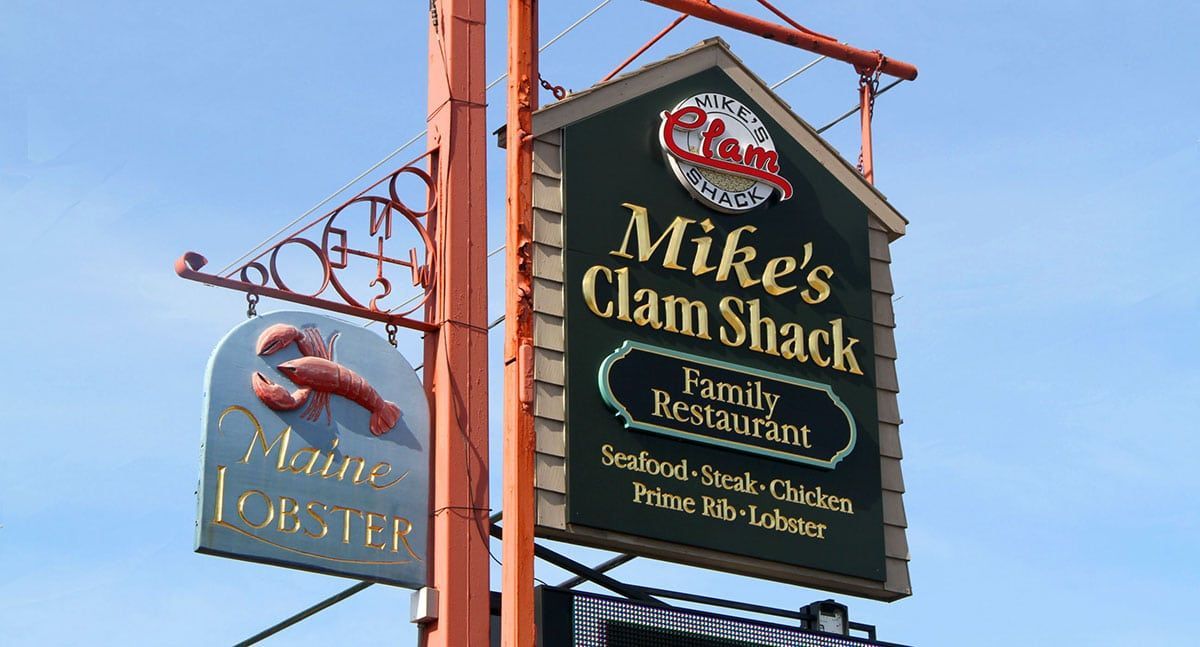 Sign for Mike's Clam Shack, a family restaurant, with a lobster and 