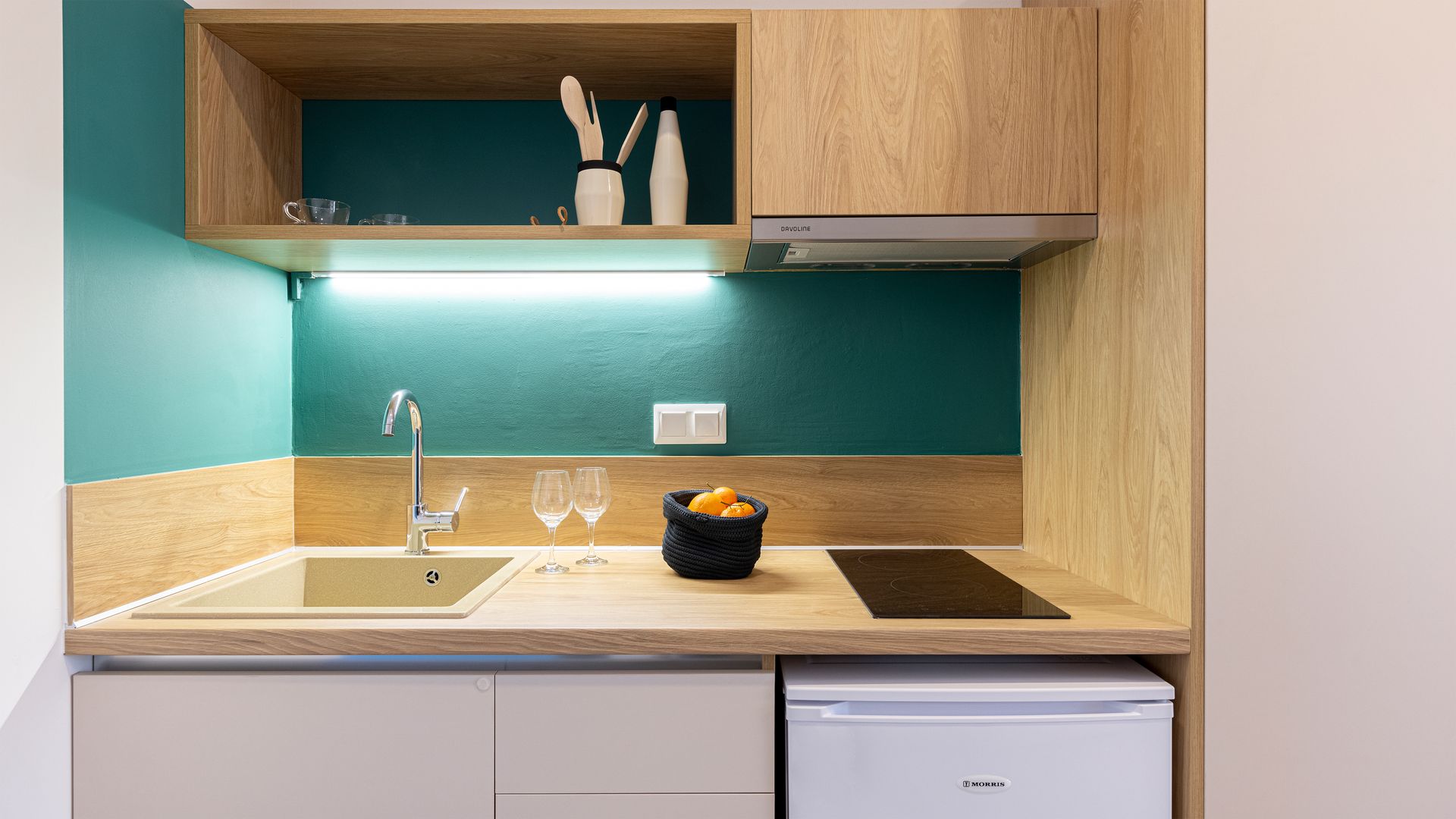 A small kitchen with a sink , stove , and refrigerator.