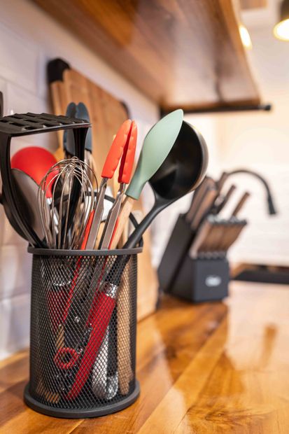 close up of kitchen utensils on wooden counter top