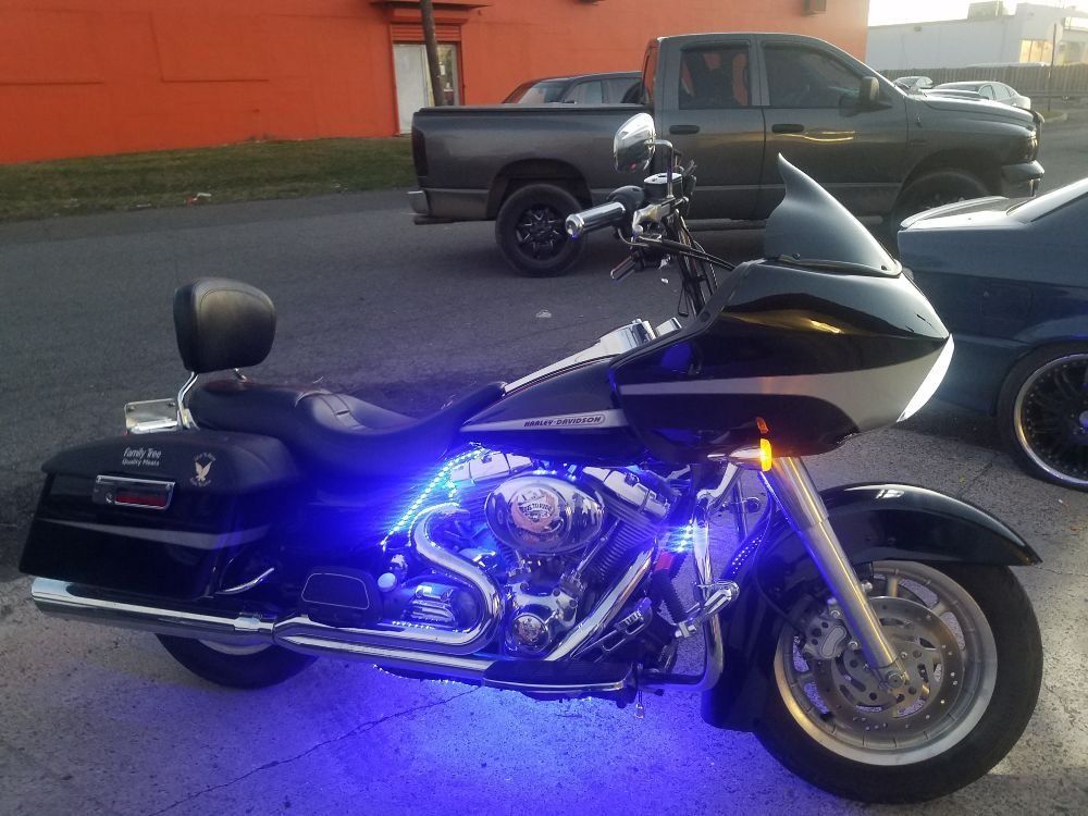 A harley davidson motorcycle is parked on the side of the road