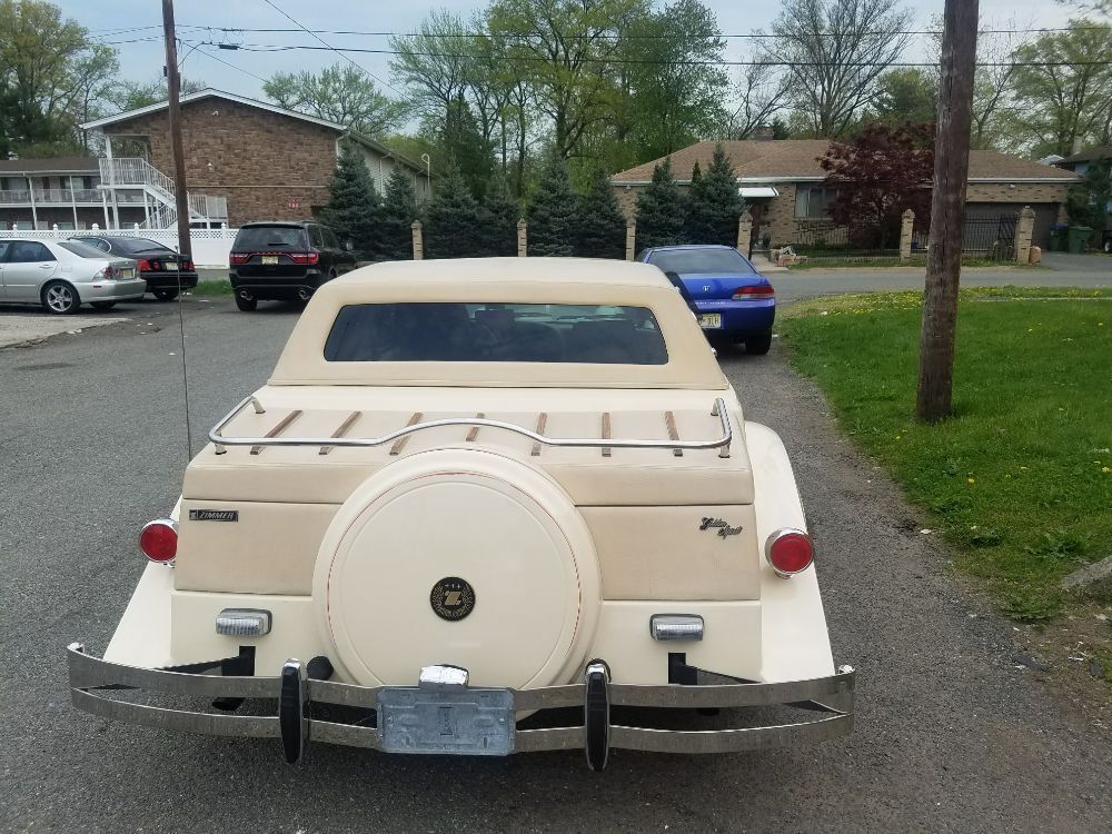 A white car is parked on the side of the road