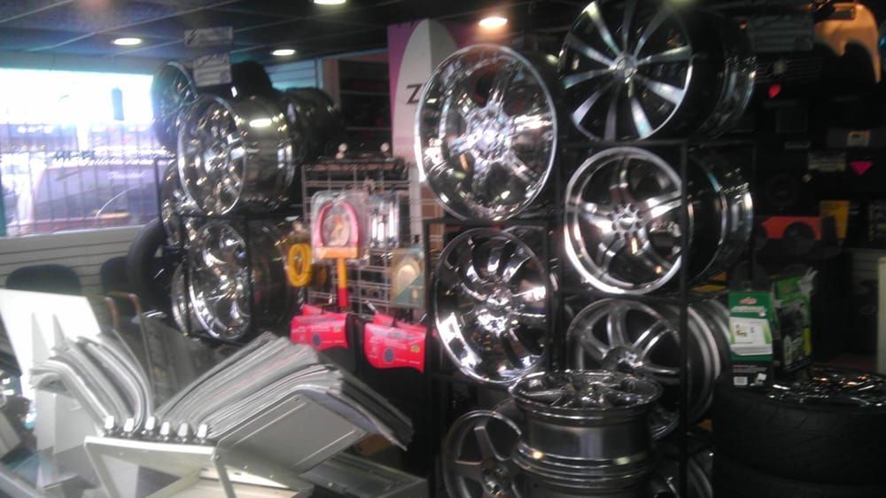 A bunch of wheels are hanging on a wall in a store