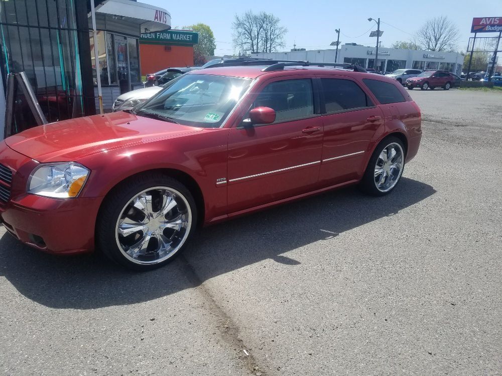 A red dodge magnum is parked in a parking lot
