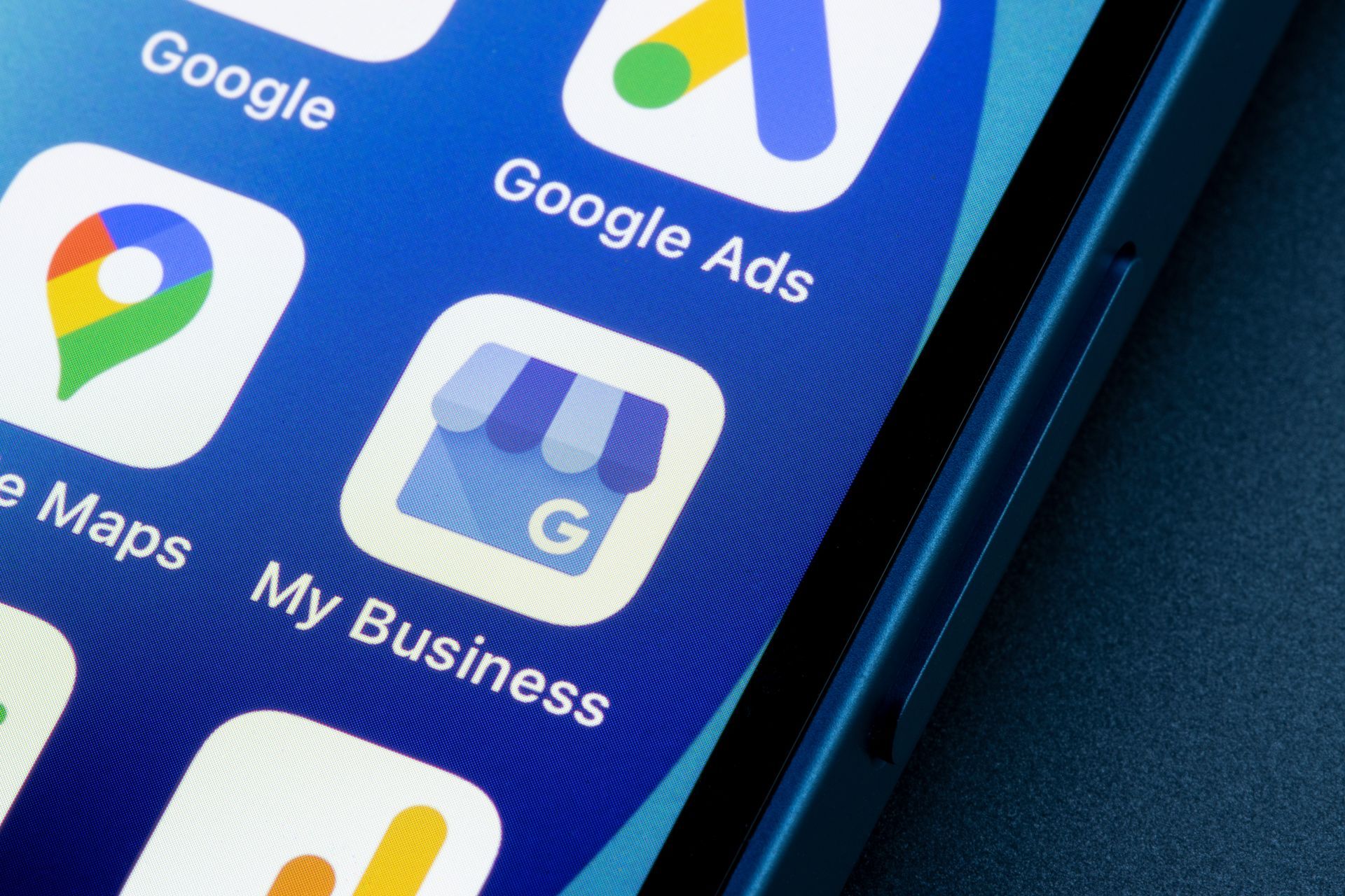 Close-up of a smartphone screen with Google app icons, including Google Ads and Google My Business.