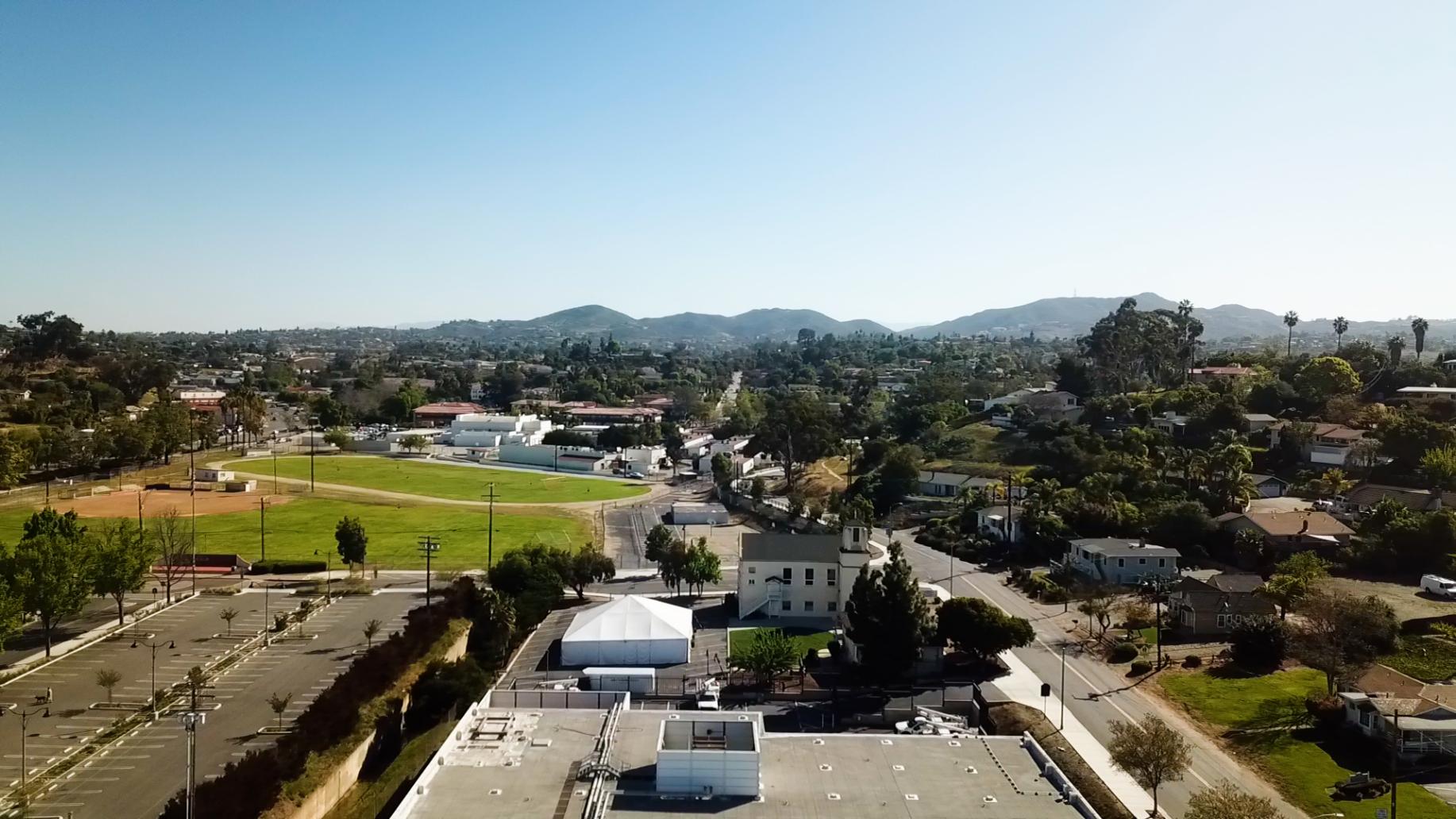 An aerial view of a city with mountains in the background