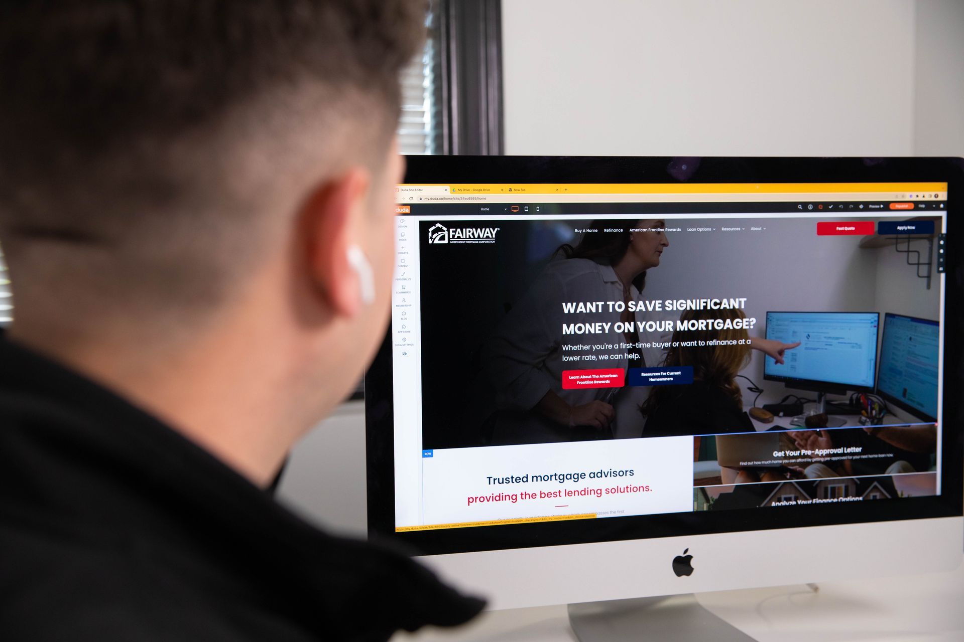 A man is looking at a computer screen that says ' identity ' on it