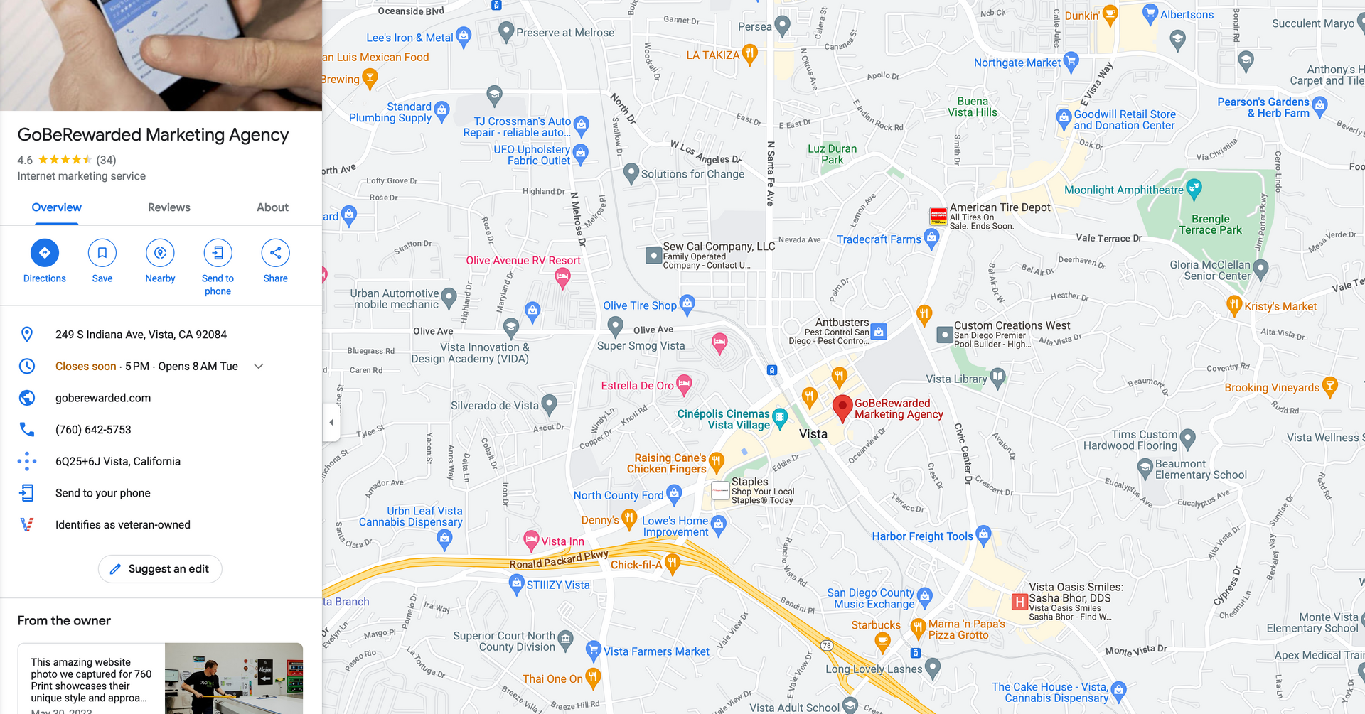 A person holding a cell phone next to a map