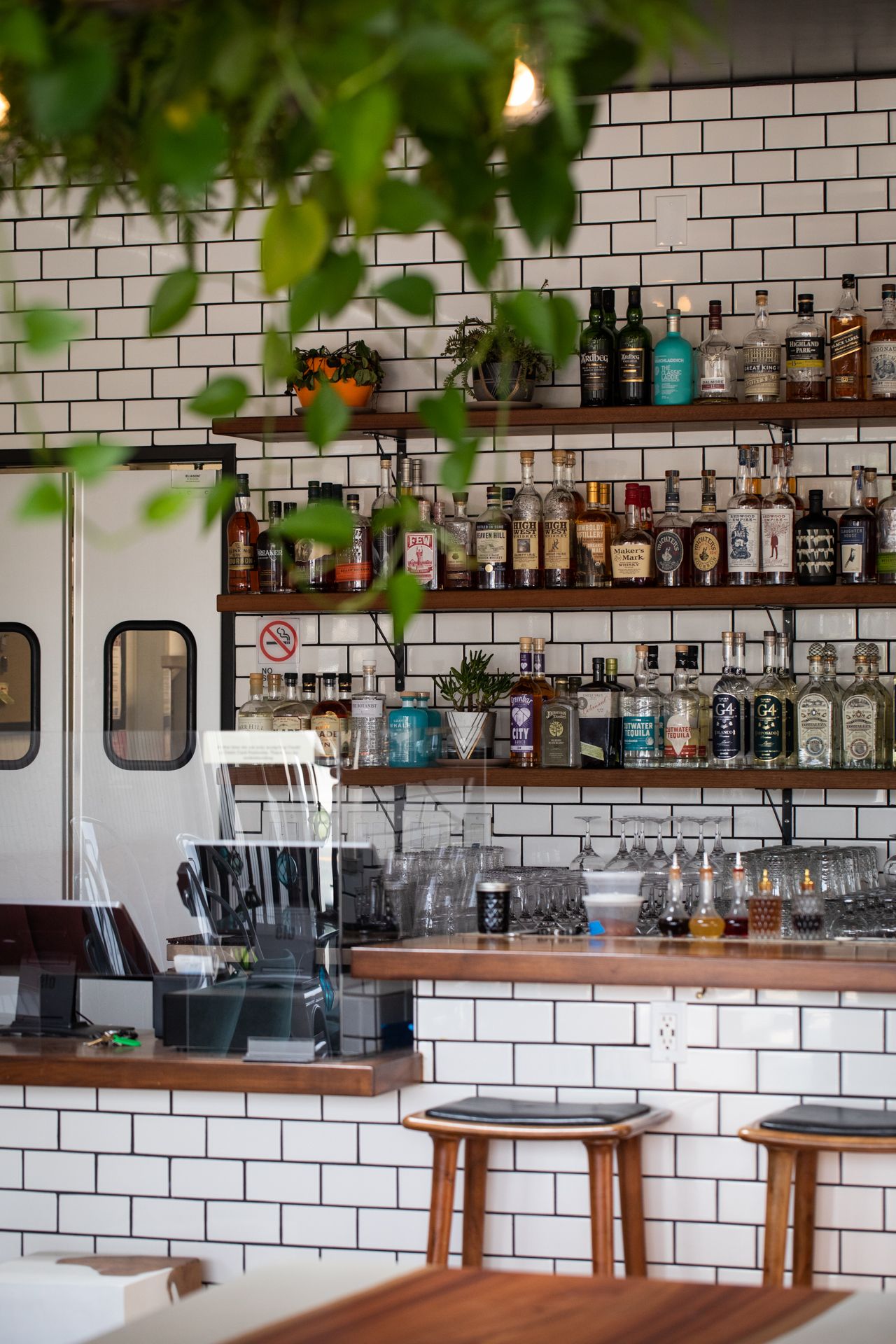 a fancy bar restaurant with glass bottles on a shelf