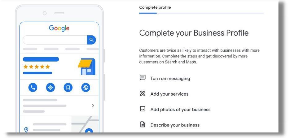 A phone is sitting next to a sign that says `` complete your business profile ''.