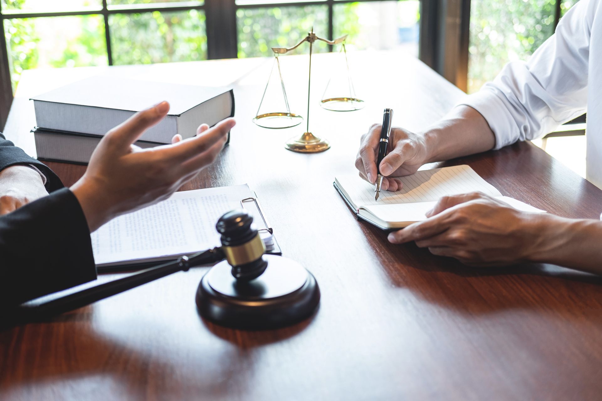 Professional male lawyer or counselor discussing negotiation legal case with client meeting with document contract in office