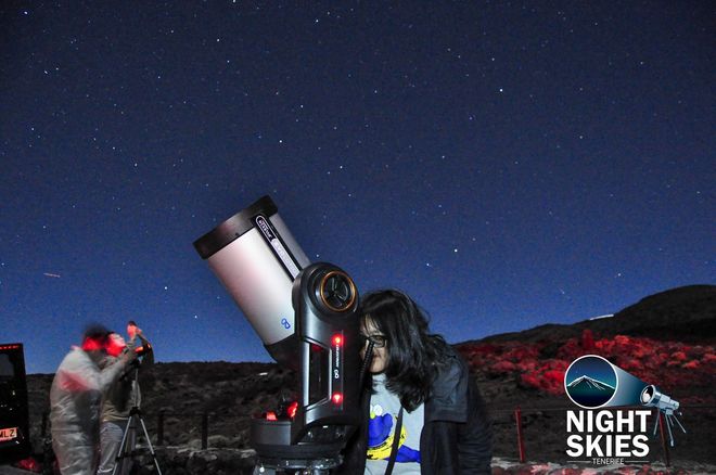 Guest observing the night sky through a telescope with Night Skies Tenerife