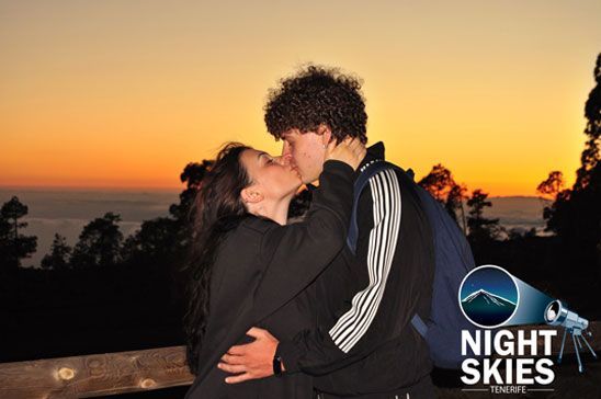 Couple sharing a kiss against the golden Tenerife sunset