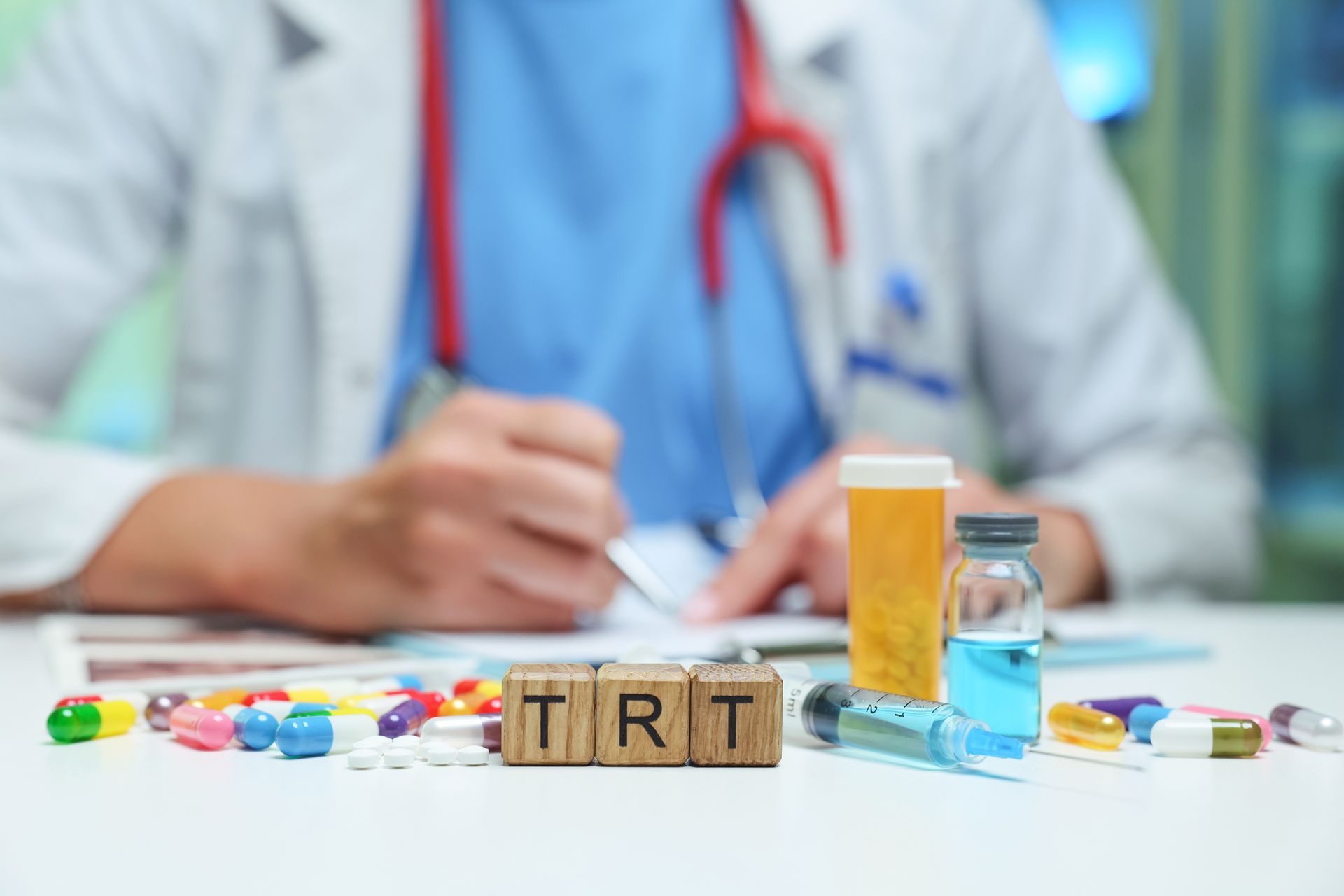 Doctor writing prescriptions with pills, medicine bottles, and wooden blocks spelling “TRT” on a desk