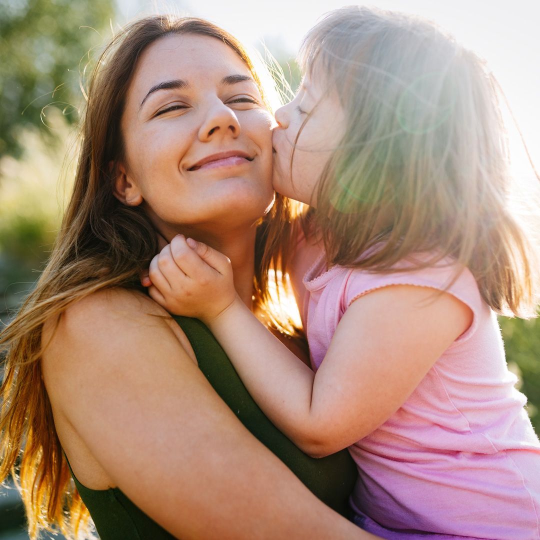 Mother and daughter hugging