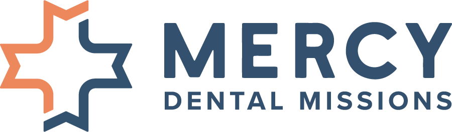 Mercy Dental Missions logo with blue text and an orange-and-blue cross icon