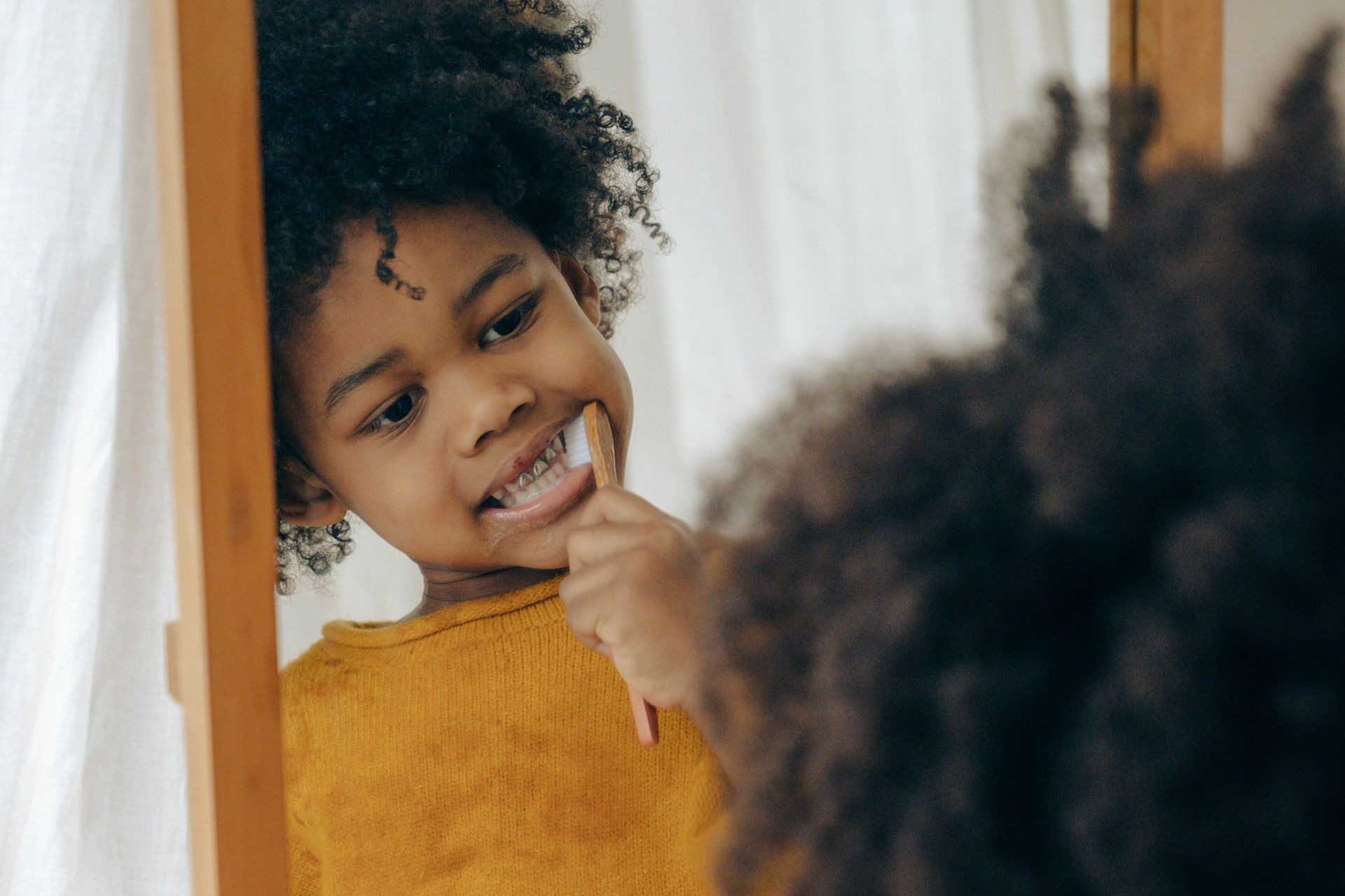 Kid brushing teeth.
