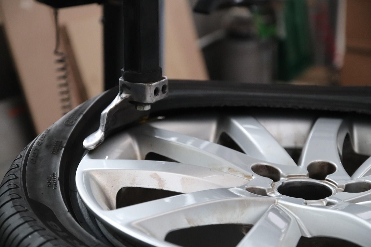 A close up of a tire being changed on a machine