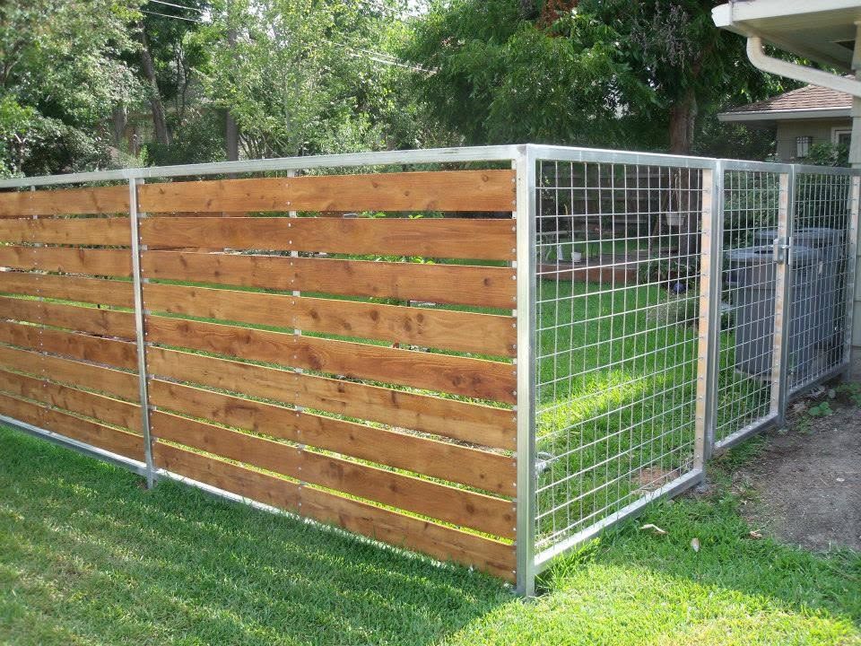 Wooden slat fence with silver wire mesh panels around a grassy yard