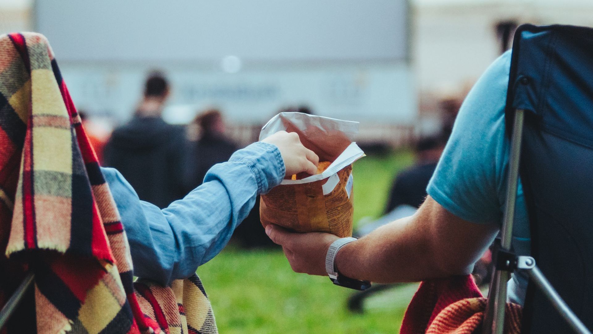 two people sharing a bag chips