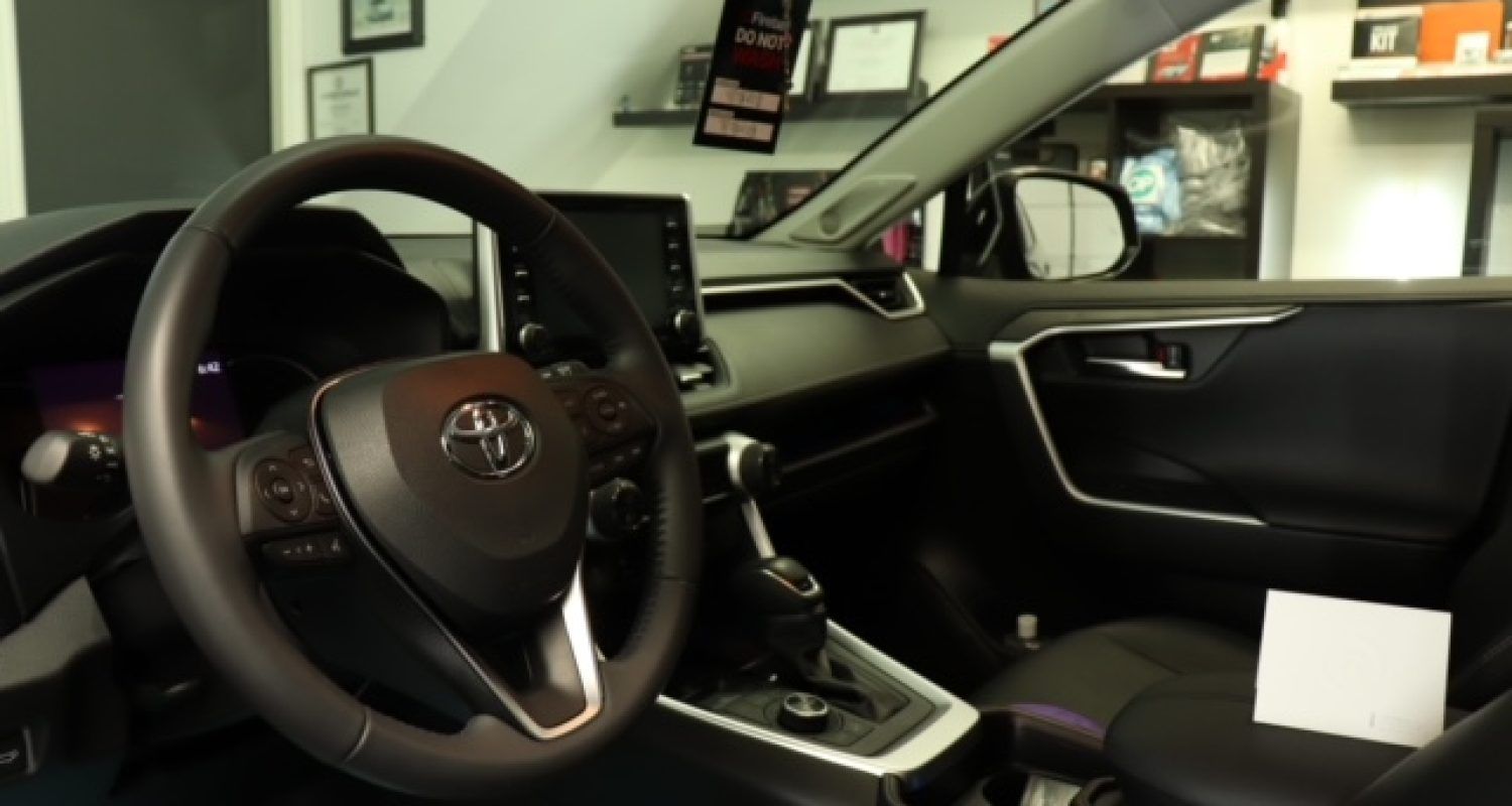 The interior of a toyota rav4 with a steering wheel