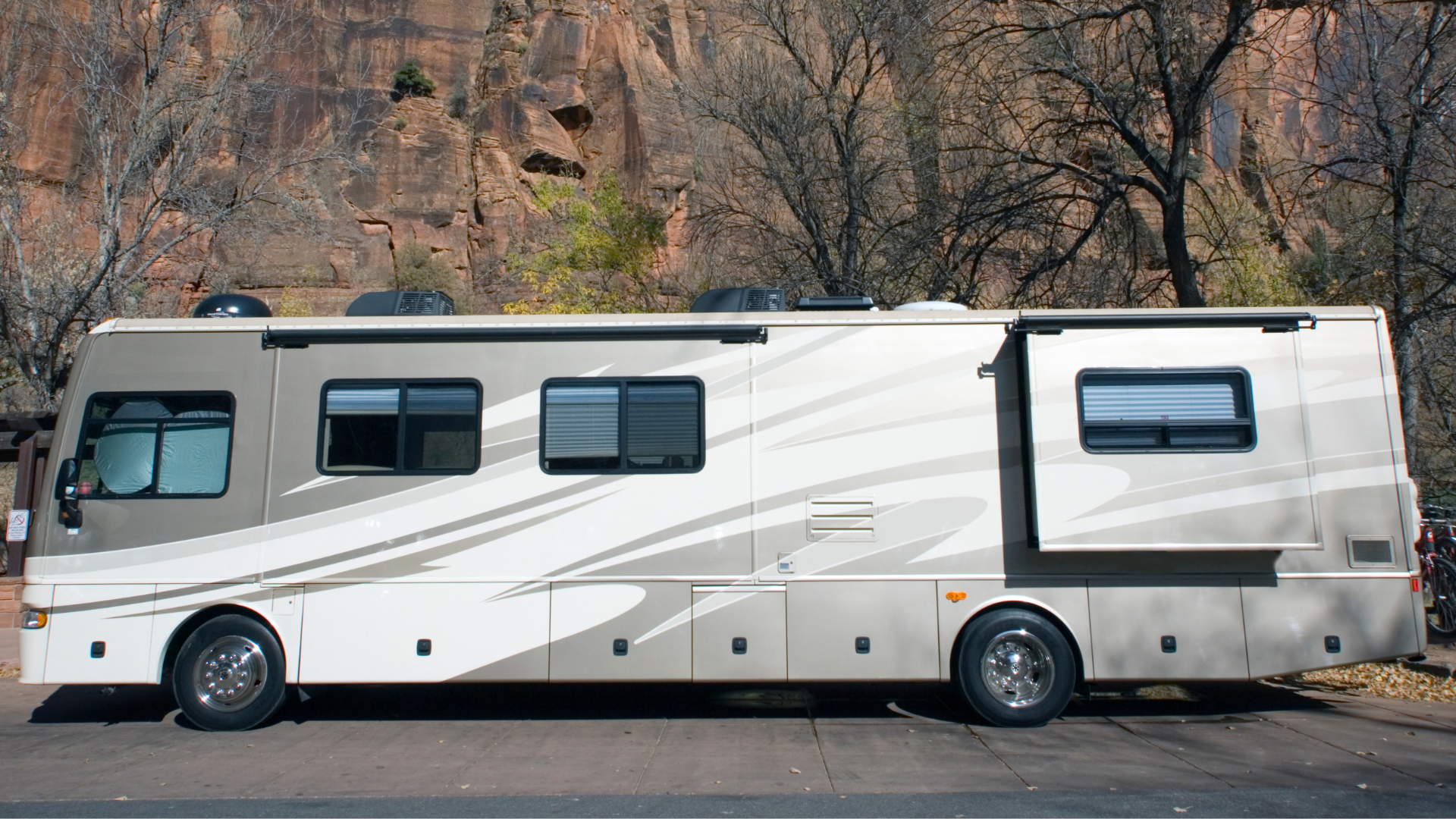 A large rv is parked on the side of the road.