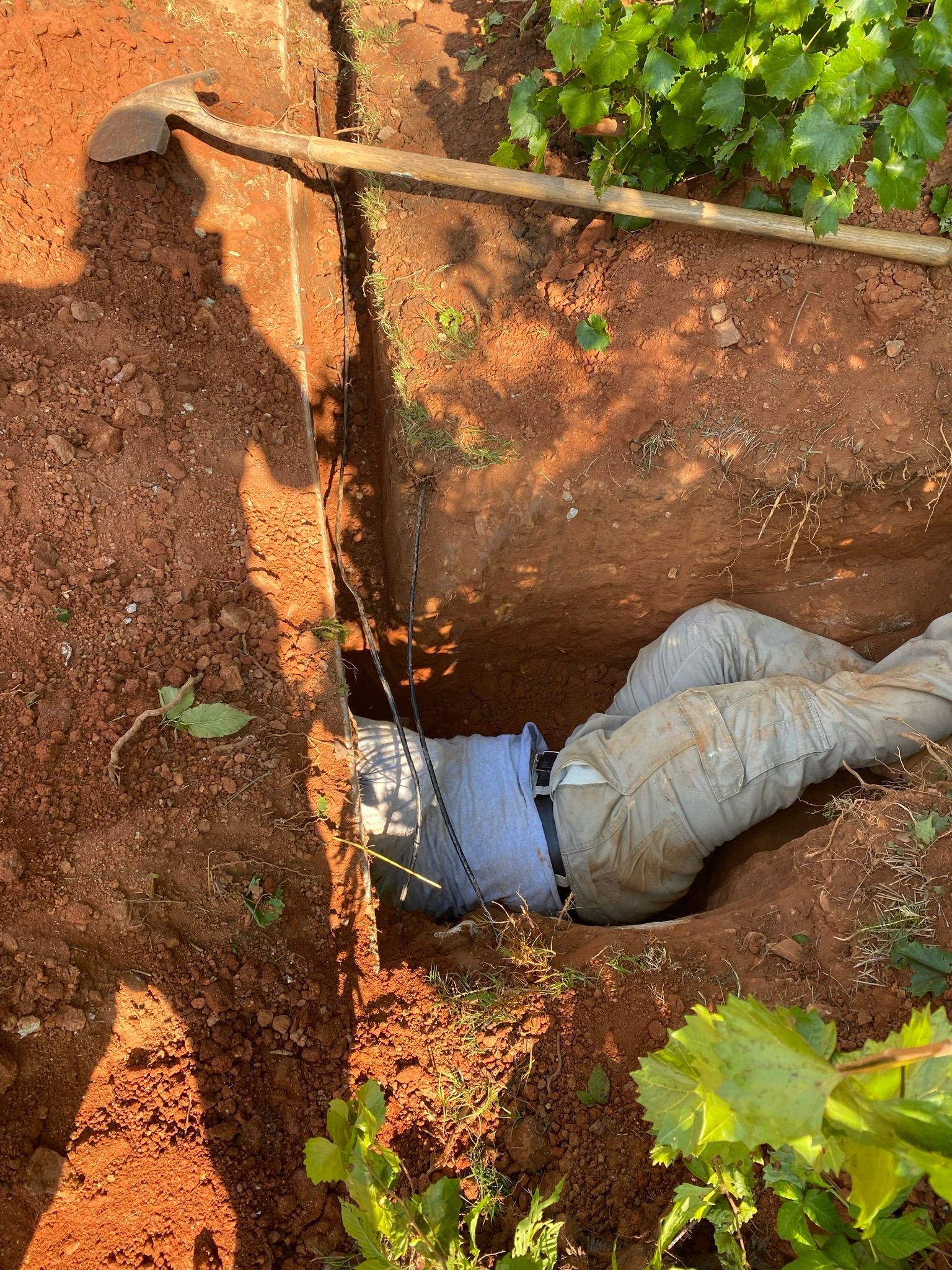 Man Doing Work on a Pit — Flowery Branch, GA — All About Irrigation and Landscape Services Inc