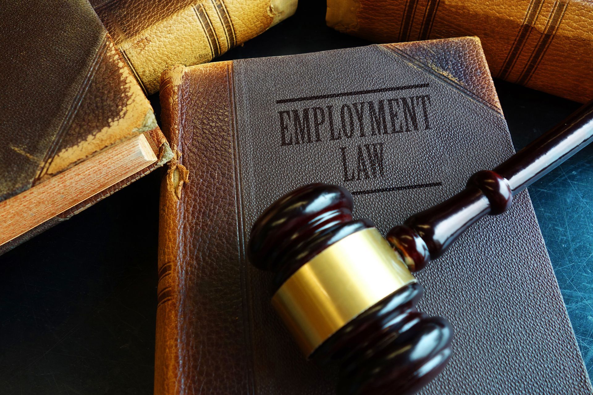 Close-up of employment law book and gavel symbolizing employment attorney legal services. Close-up of employment law book and gavel symbolizing employment attorney legal services.