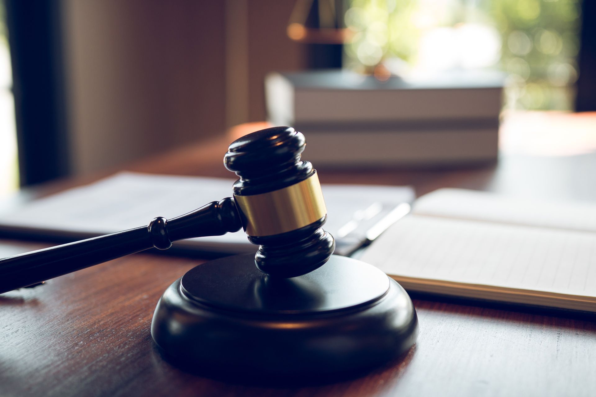 Judge gavel and sound block on wooden courtroom desk symbolizing law justice and legal authority.