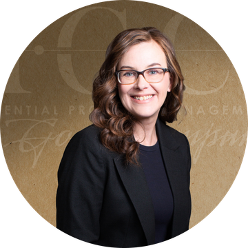 Woman with glasses smiling, wearing a black blazer. Brown and tan background with text.