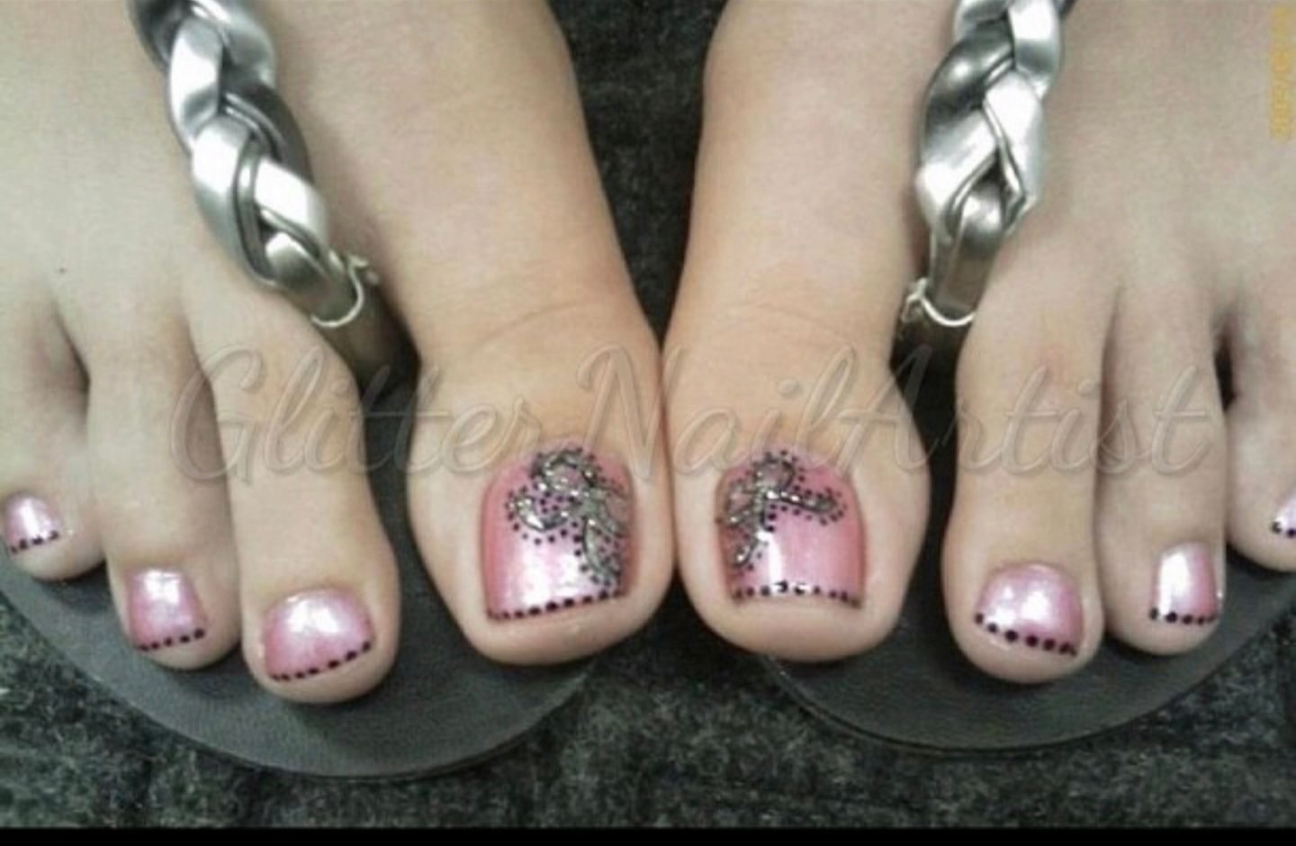 Hand with long almond nails in purple and lilac plaid and swirl nail art