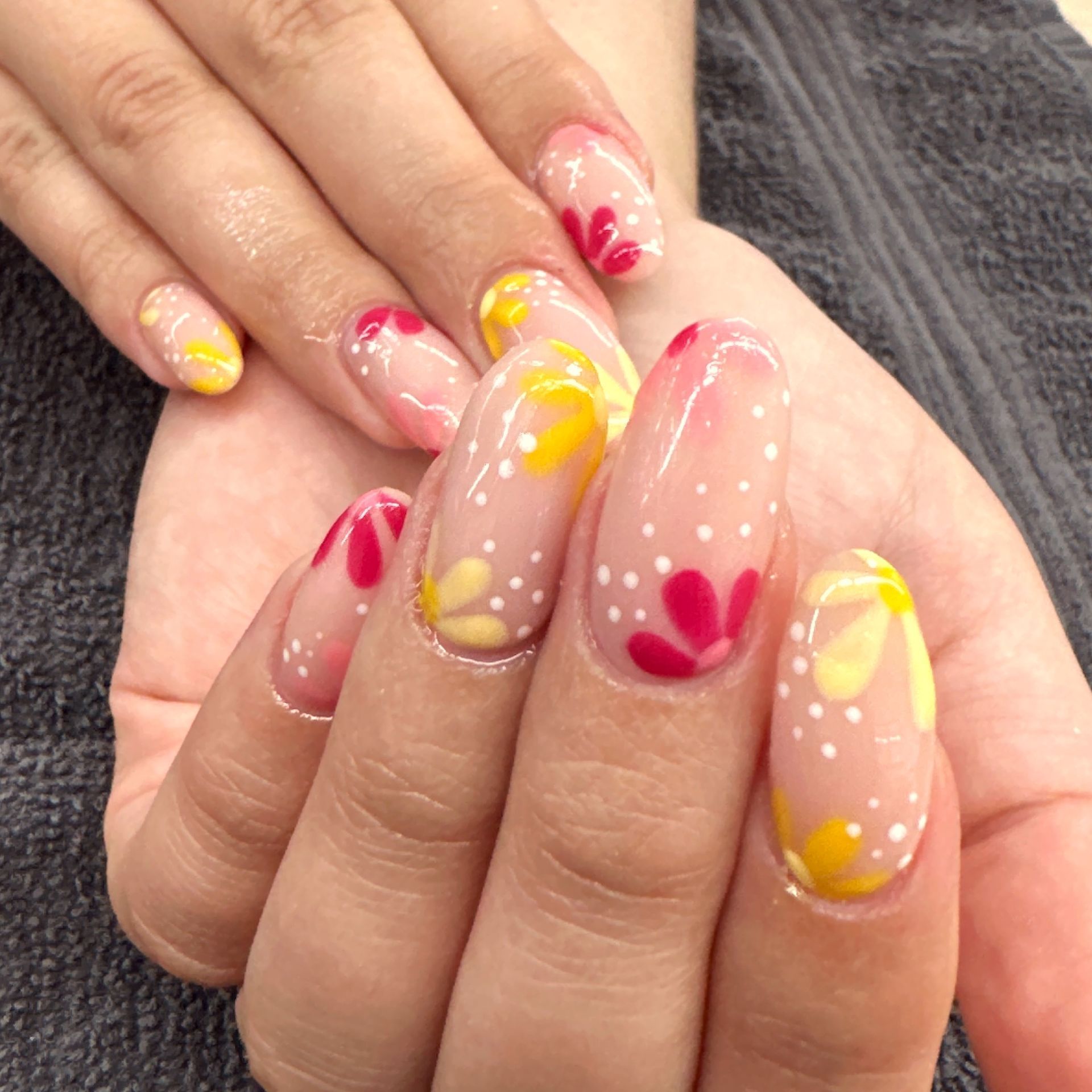 Hand with pastel blue and gold glitter ombré manicure, shown close-up on fingers and nails