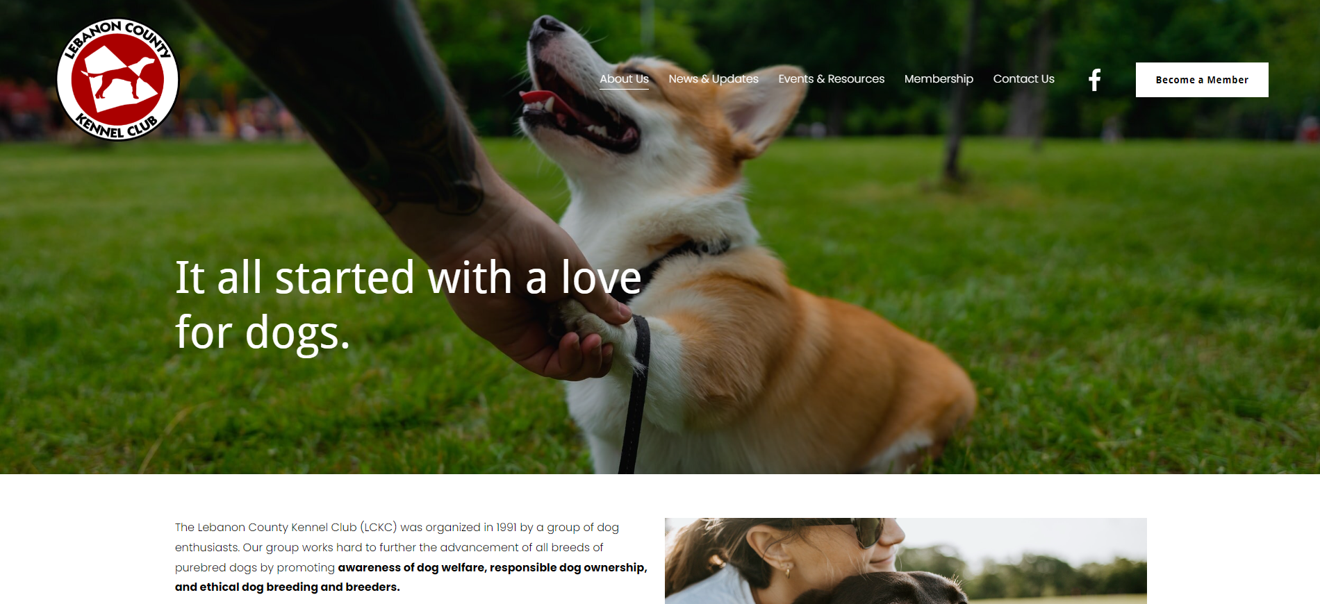 A corgi being held on a leash by a person, on a grassy field. Text reads