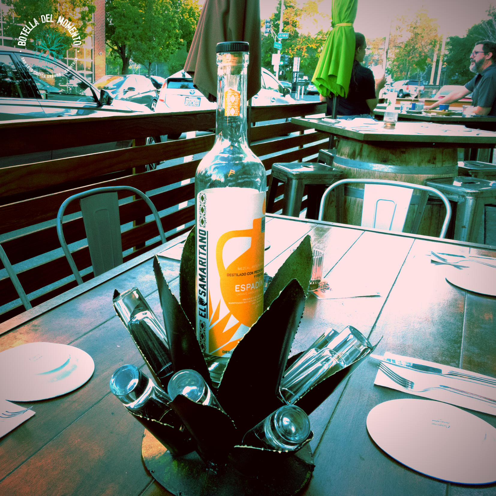 A bottle of tequila sits on a wooden table