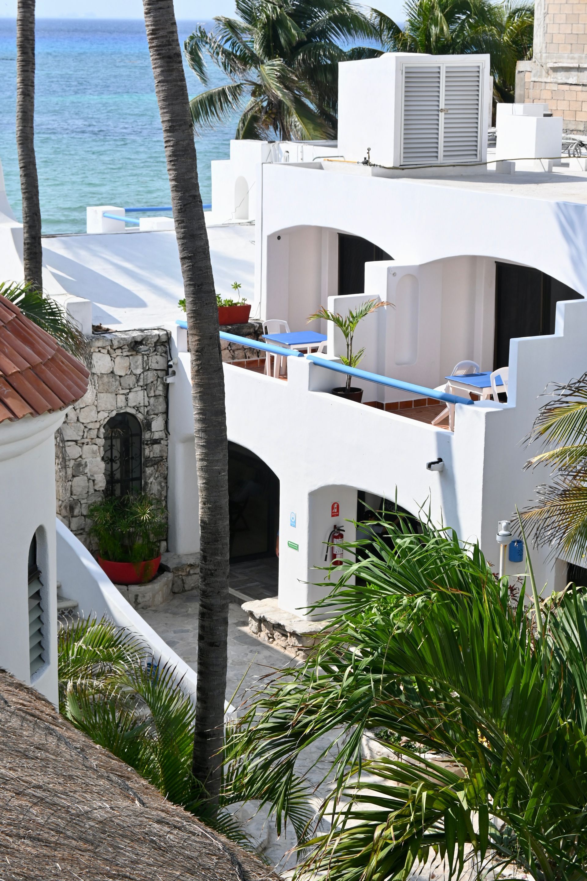 Un edificio blanco con un balcón con vista al mar.