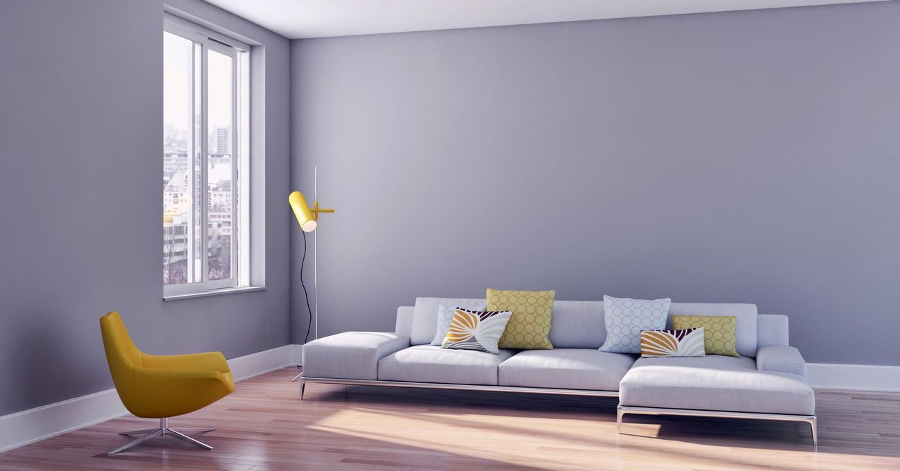Modern living room with light gray walls, white couch, yellow chair and floor lamp, window in Monona, Wisconsin.