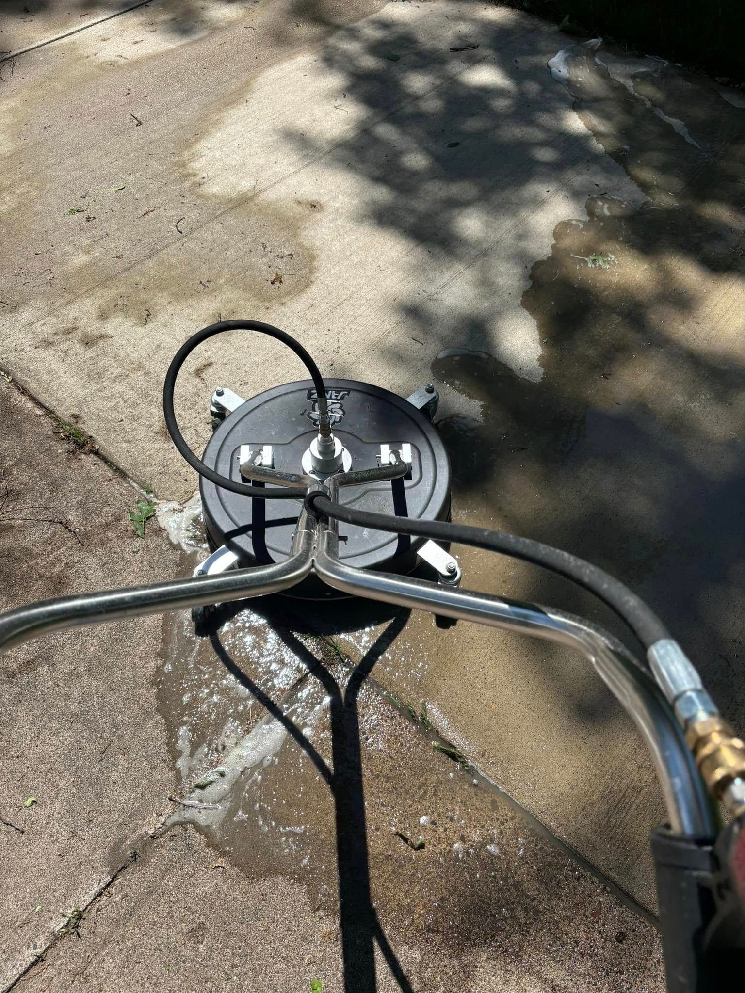 Close-up of a bicycle handlebar and stem over cracked pavement in sunlight.